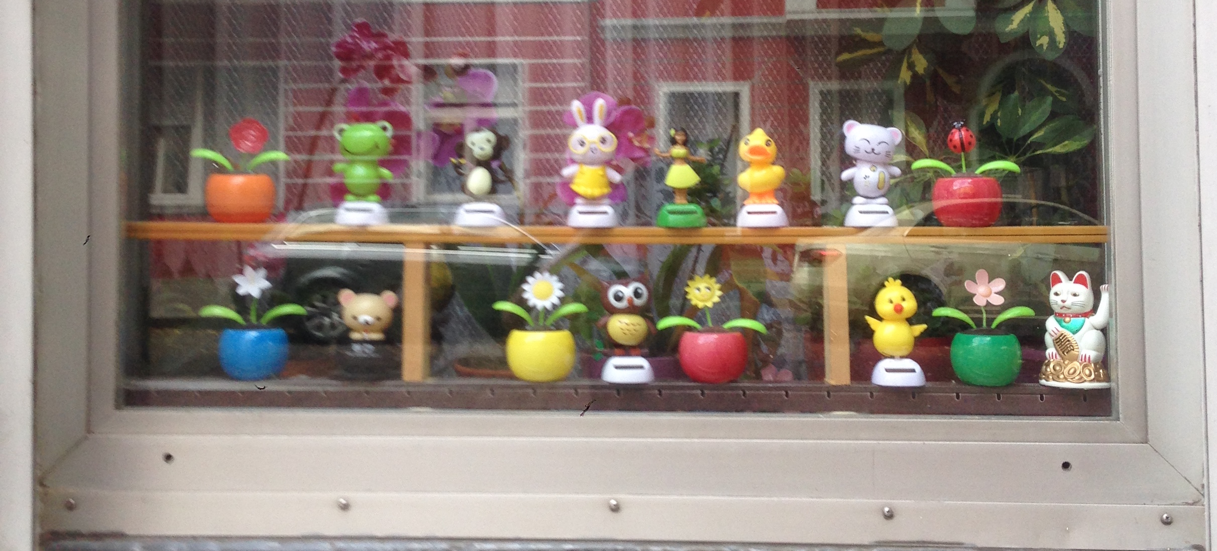 A window full of solar powered tchotchkies